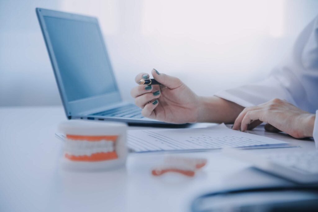 dentists are discussing dental problems report xray image laptop screen patients